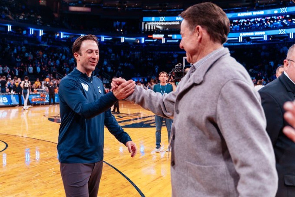 Richard and Rick Pitino shake hands after Xavier's victory over Marquette